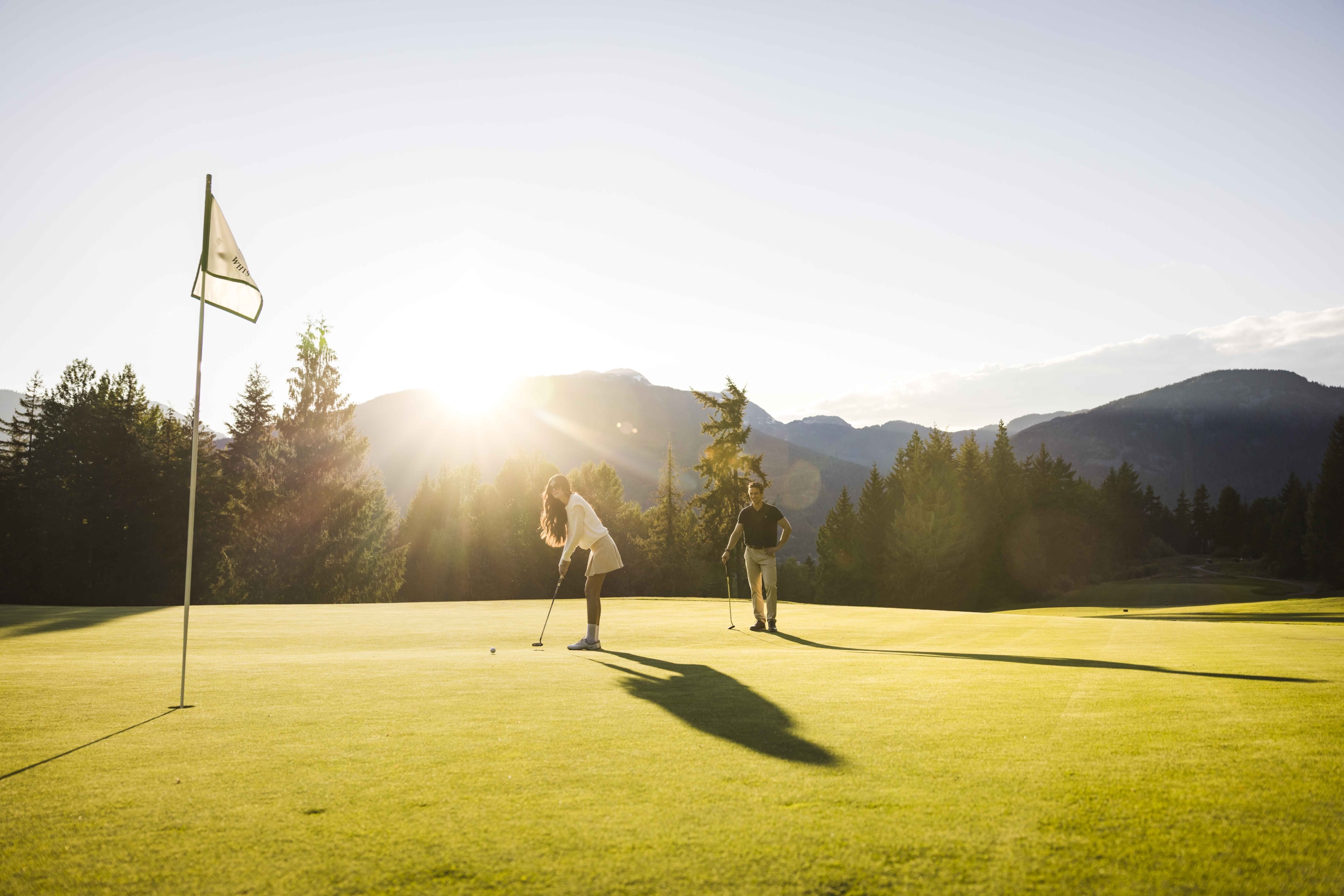 A couple playing at the Fairmont Chateau Whistler Golf Course