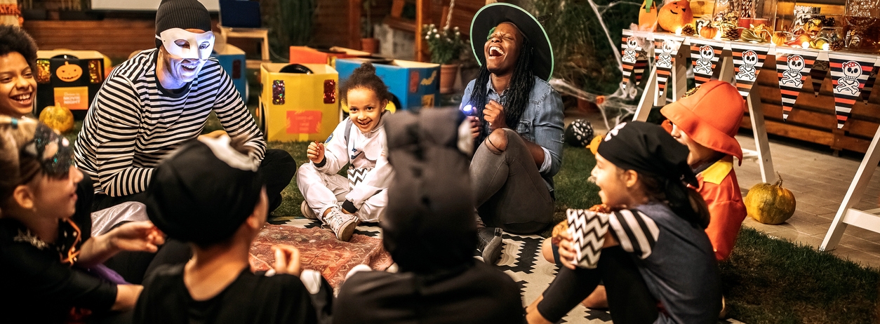 children sitting in circle reading spooky stories