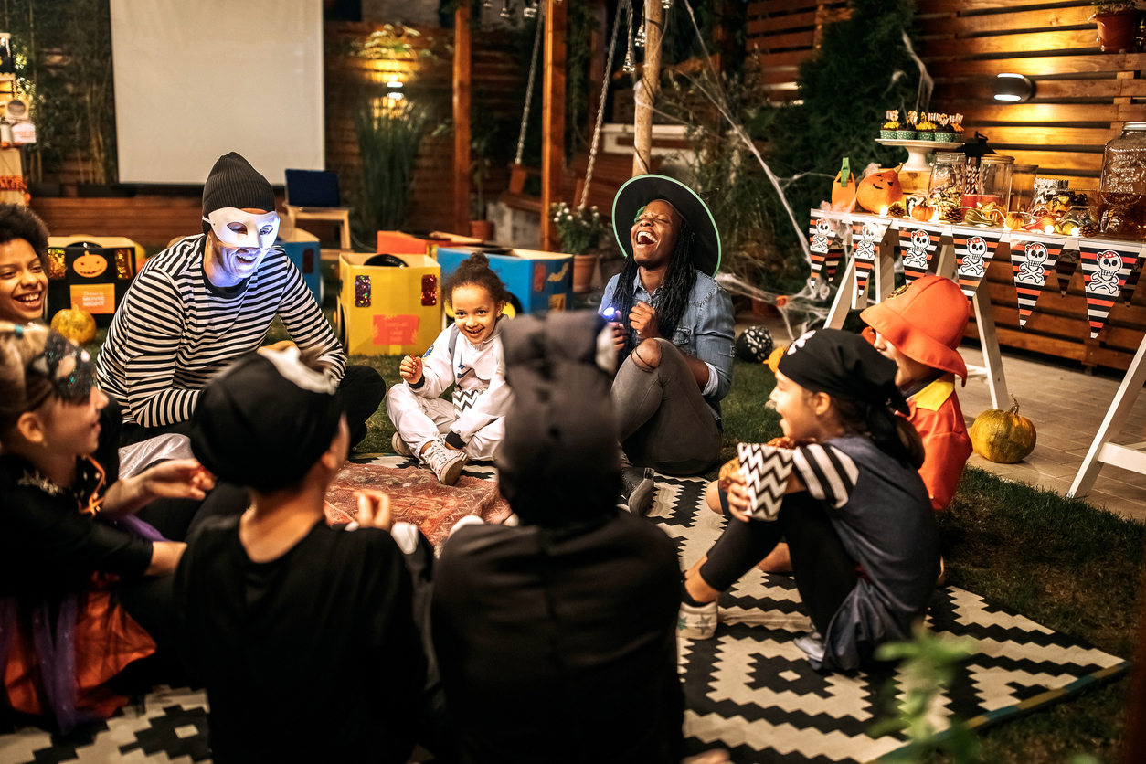 children sitting in circle reading spooky stories