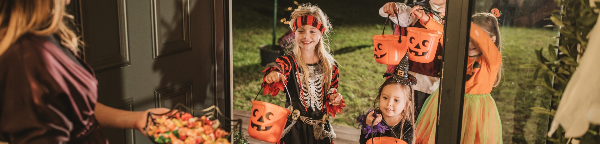 children trick or treating in their halloween costumes