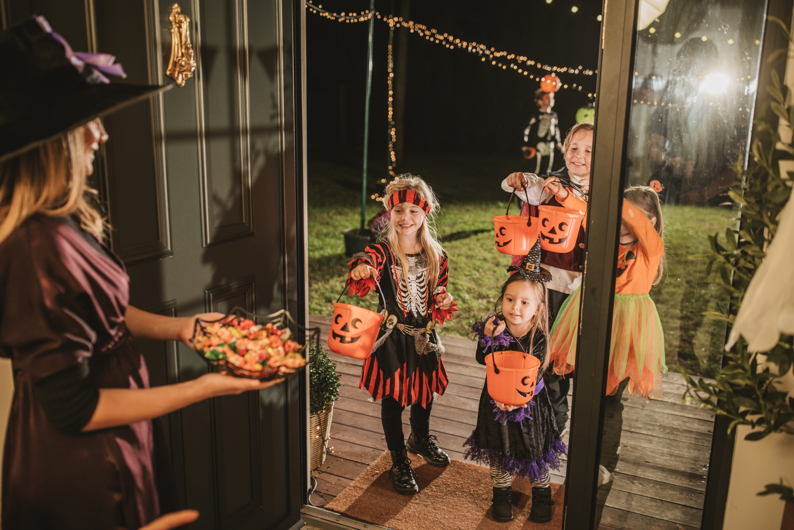 children trick or treating in their halloween costumes