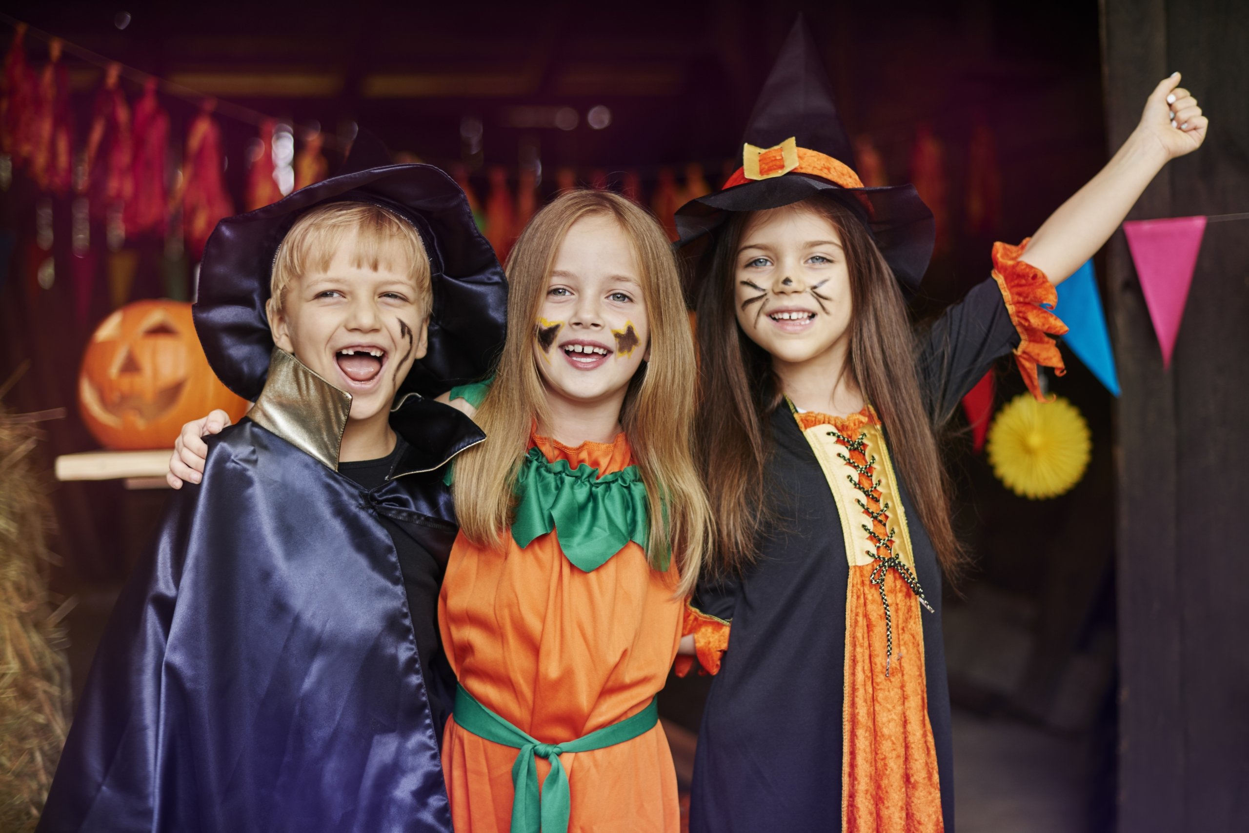 kids posing for a photo in halloween costumes
