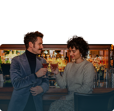 Couple enjoying a festive cocktail at the Mallard Lounge at Fairmont Chateau Whistler