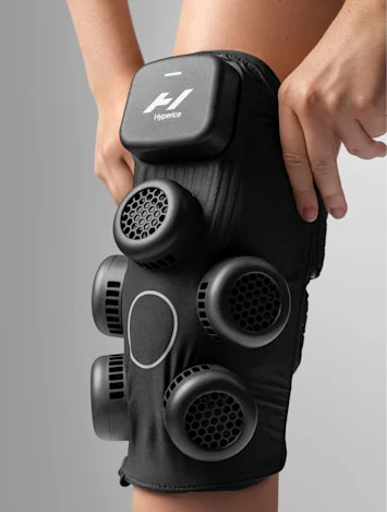 hyperice X Knee equipment with someone pulling the device onto their knee