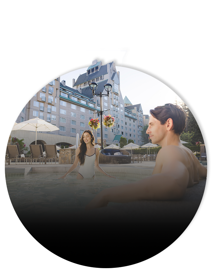 couple at the pool health club enjoying spring escape offer fairmont chateau whistler